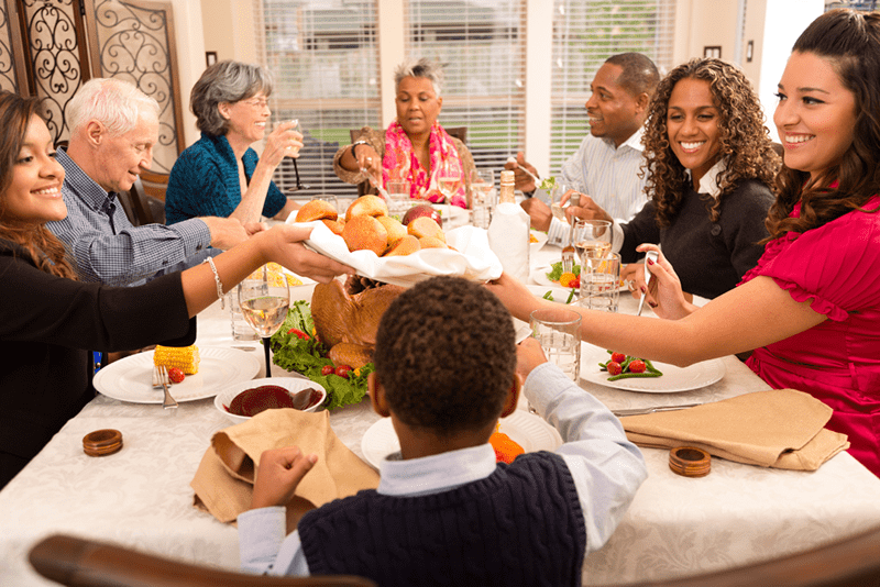 A group of people sitting around a table eating.